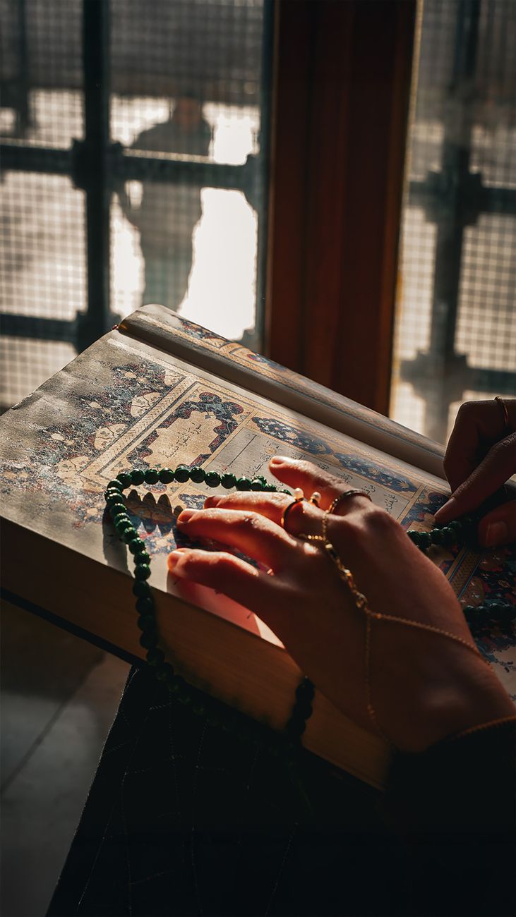 contemplative moment with prayer beads and manuscript